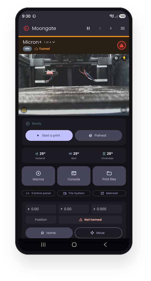 The Moongate single-printer dashboard on a phone. A pinned header shows the printer Micron+, 1 of 4, idle and connected over the tunnel, with the emergency stop beside it. Below it: the printer's camera, a Ready card offering Start a print and Preheat, the hotend, bed and chamber temperatures, large Macros, Console and Print files buttons with Control panel, File System and Mainsail beneath them, and the live X Y Z position with a Home button.
